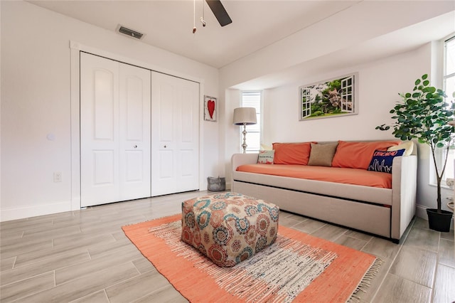 living room featuring ceiling fan and light hardwood / wood-style floors