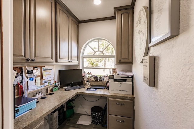 home office featuring crown molding, tile patterned flooring, and built in desk