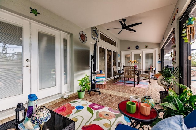 sunroom with french doors, vaulted ceiling, plenty of natural light, and ceiling fan