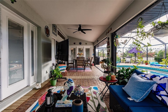 sunroom with ceiling fan, french doors, and lofted ceiling