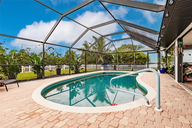 view of swimming pool featuring a patio and a lanai