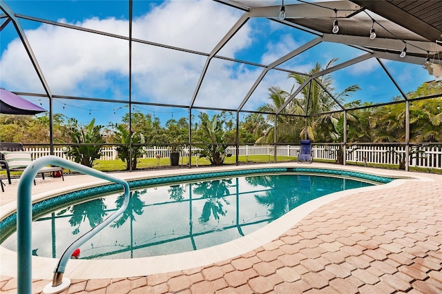 view of swimming pool with a lanai