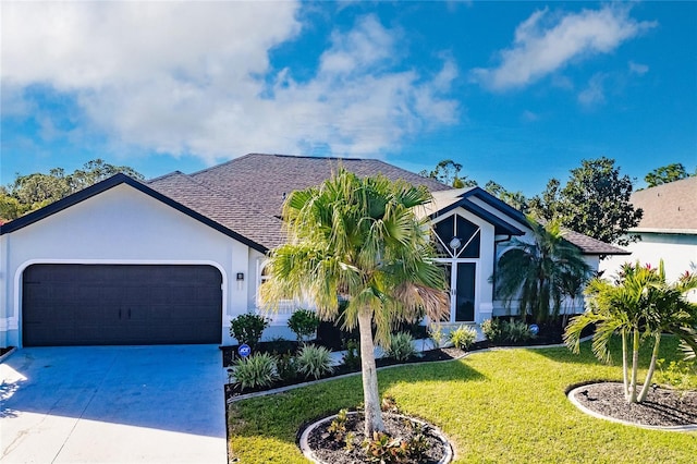 view of front facade with a garage and a front lawn