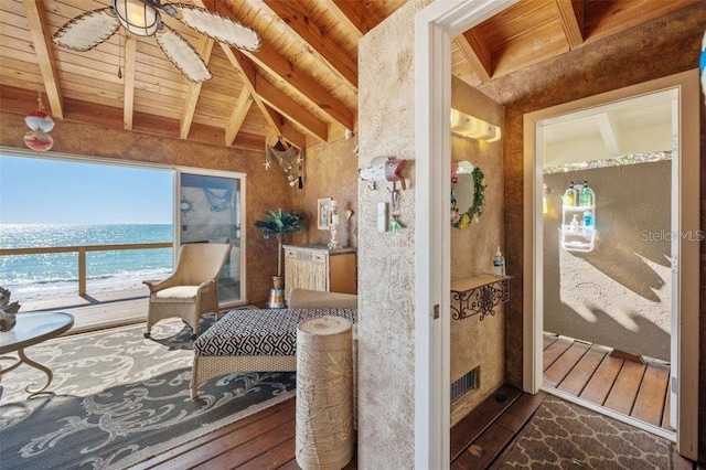 interior space with dark hardwood / wood-style flooring, vaulted ceiling with beams, a water view, and wooden ceiling