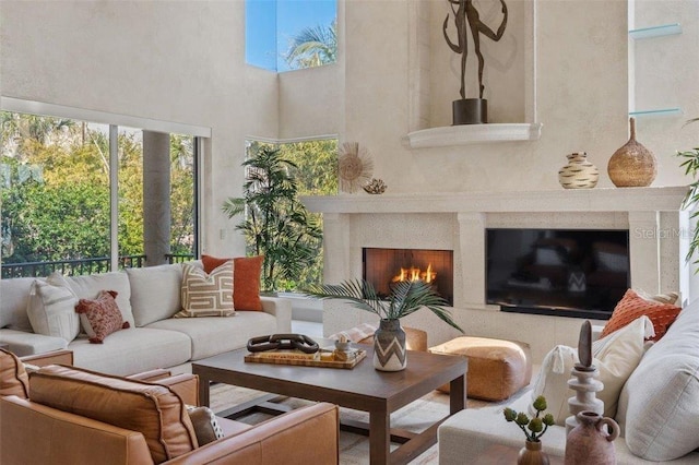 sunroom / solarium featuring exterior fireplace and a skylight