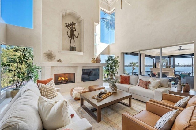 living room featuring a high ceiling and a water view