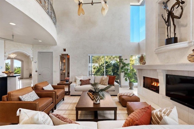 living room featuring a high ceiling and an inviting chandelier