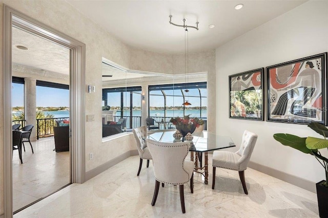 dining area featuring a water view