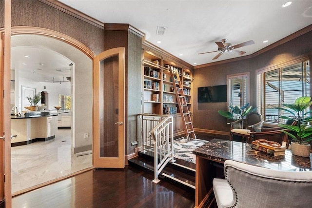 living area with ceiling fan, crown molding, wood-type flooring, and built in features