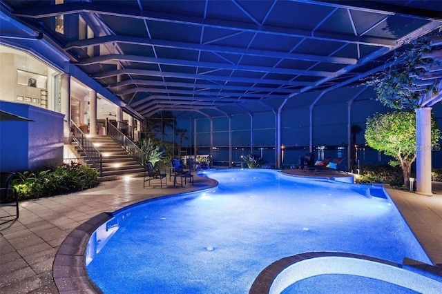 view of pool with a patio and a lanai