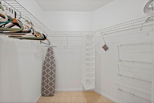 spacious closet featuring light tile patterned floors