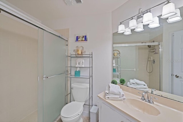 bathroom featuring toilet, a stall shower, visible vents, and vanity