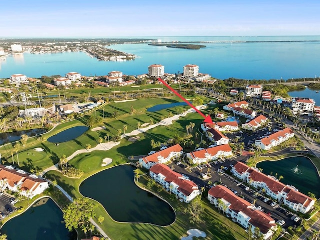 drone / aerial view with a water view, a view of city, and golf course view