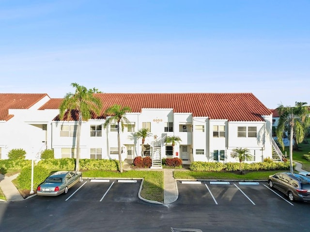 view of building exterior featuring uncovered parking and a residential view