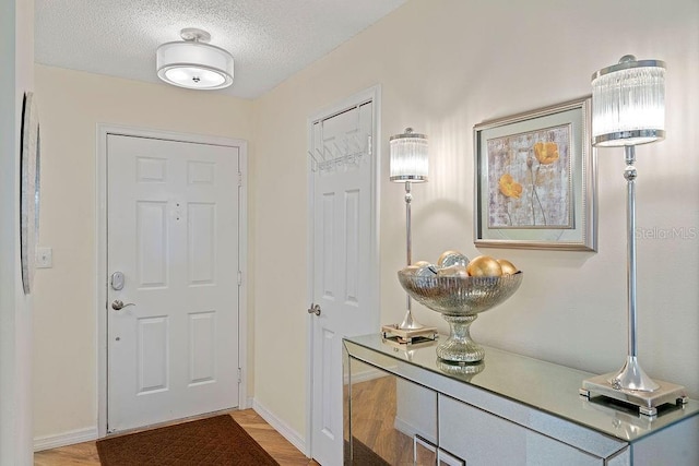 doorway to outside featuring hardwood / wood-style flooring and a textured ceiling