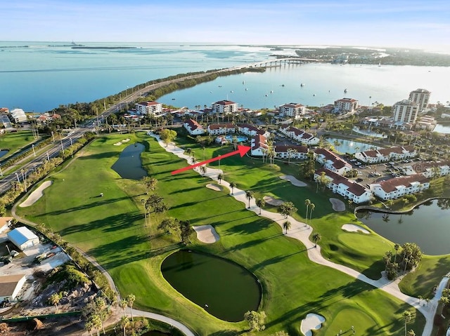 birds eye view of property featuring a view of city, view of golf course, and a water view