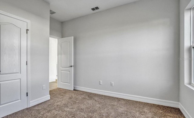 unfurnished bedroom featuring light carpet