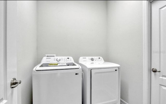 clothes washing area with separate washer and dryer