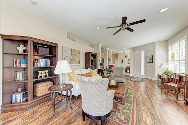 living room with ceiling fan and light wood-type flooring