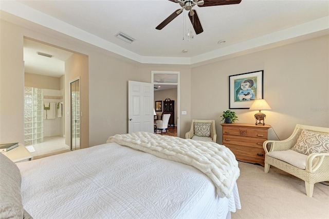 bedroom featuring connected bathroom, ceiling fan, a closet, and carpet floors