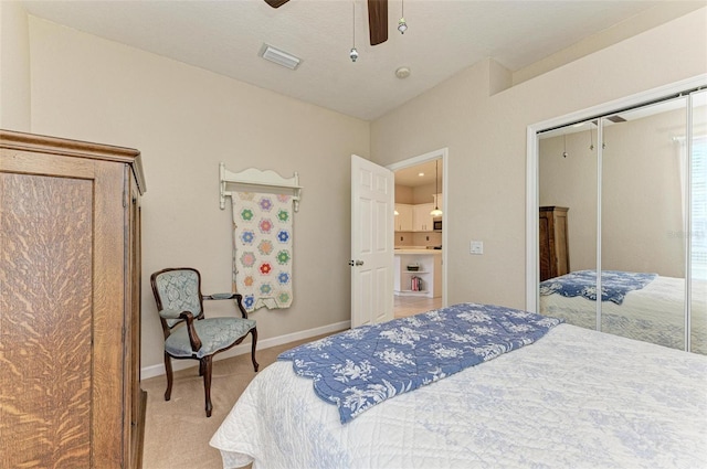 bedroom featuring light carpet, a closet, and ceiling fan