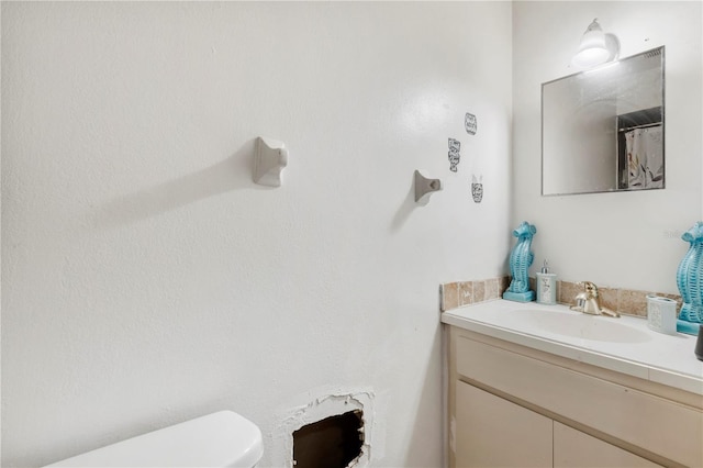 bathroom featuring vanity and toilet