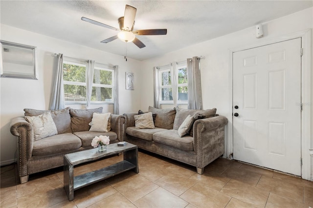 tiled living room featuring ceiling fan and a wealth of natural light