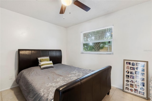 bedroom with ceiling fan and light tile patterned floors