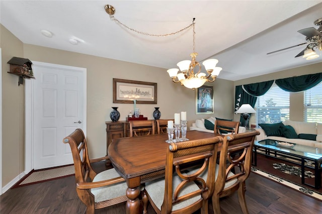 dining space with ceiling fan with notable chandelier and dark hardwood / wood-style floors