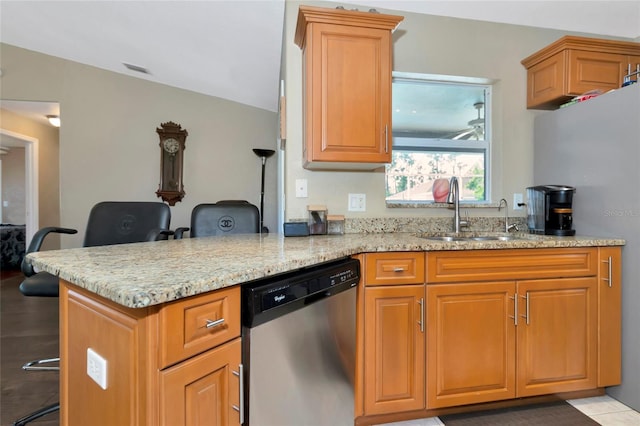 kitchen featuring sink, kitchen peninsula, ceiling fan, stainless steel appliances, and light stone countertops