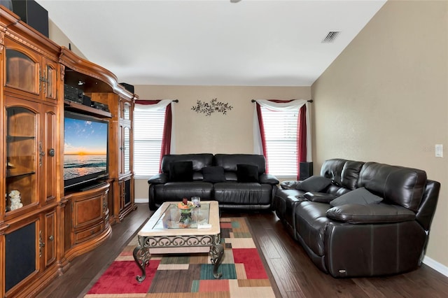 living room with dark wood-type flooring and vaulted ceiling