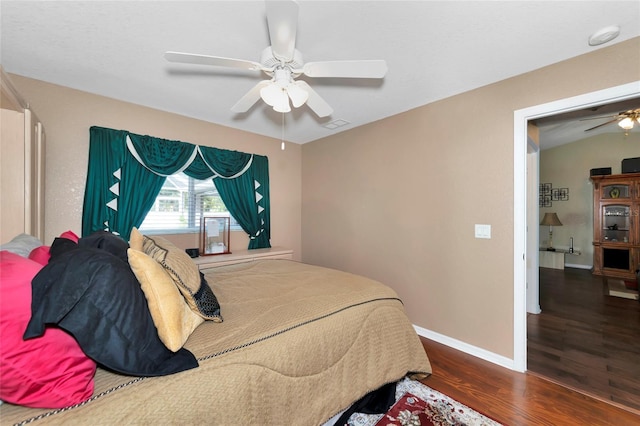 bedroom featuring ceiling fan and dark hardwood / wood-style floors