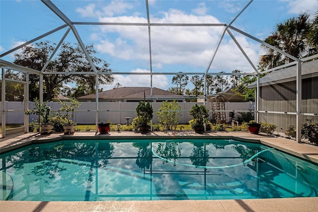 view of swimming pool with a patio and a lanai