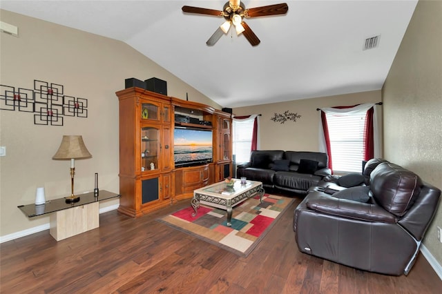 living room featuring ceiling fan, dark wood-type flooring, a healthy amount of sunlight, and vaulted ceiling