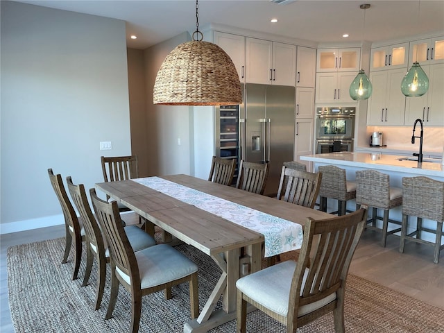 dining space featuring sink and dark wood-type flooring