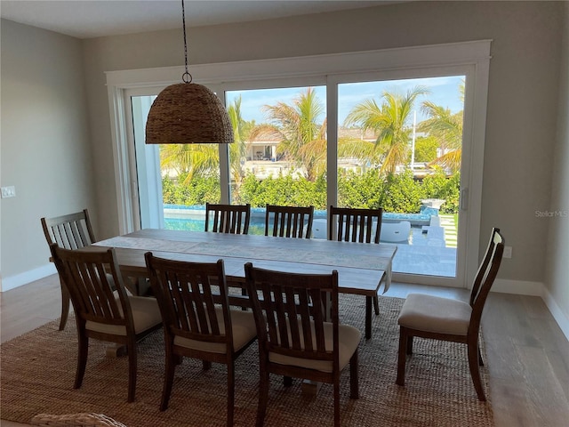 dining area featuring hardwood / wood-style flooring and a healthy amount of sunlight