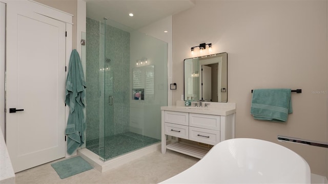 bathroom with tile patterned floors, vanity, and separate shower and tub