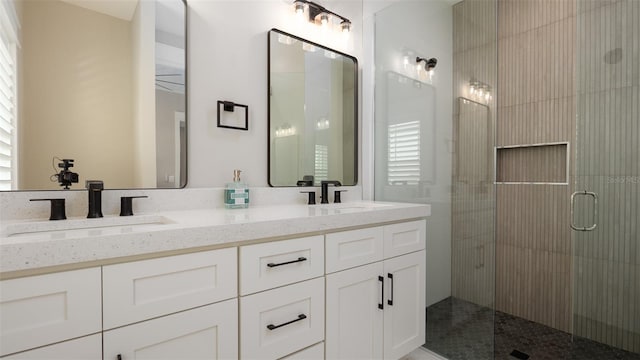 bathroom with vanity and a shower with door