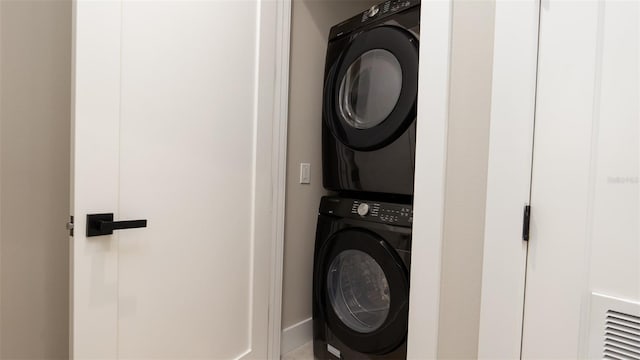 washroom with stacked washer / drying machine