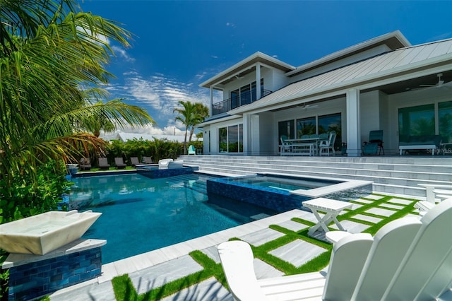 view of pool featuring ceiling fan, a patio area, and an in ground hot tub