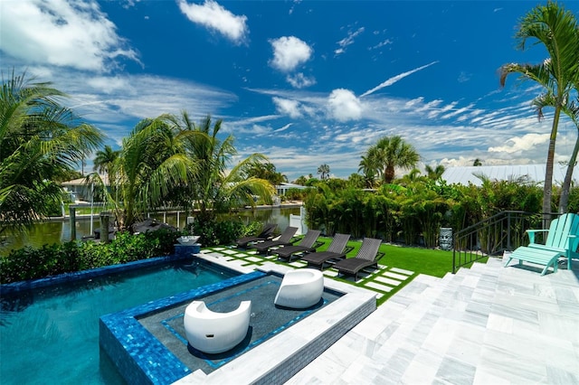 view of pool featuring a patio and a water view