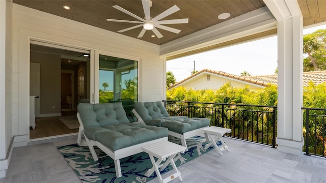 sunroom / solarium featuring a healthy amount of sunlight, ceiling fan, and wood ceiling