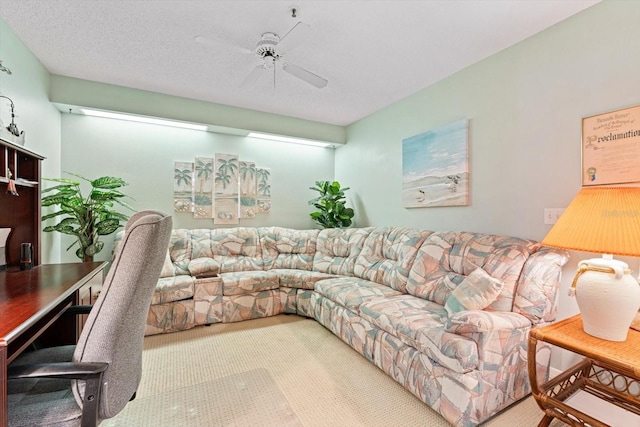 living room with carpet flooring, ceiling fan, and a textured ceiling