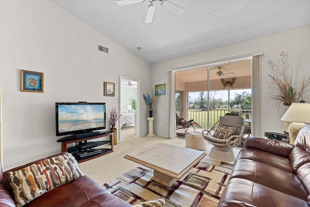 living room with light colored carpet, a textured ceiling, and high vaulted ceiling