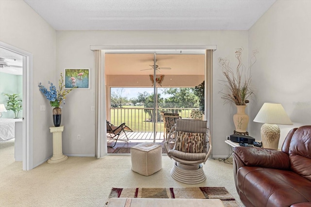 living room with ceiling fan and carpet floors