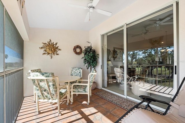 sunroom / solarium featuring ceiling fan