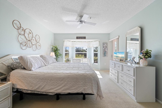 bedroom with light carpet, a textured ceiling, and ceiling fan