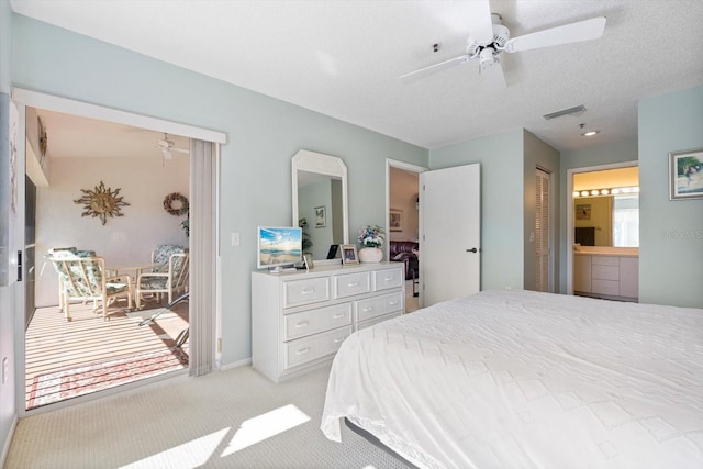 carpeted bedroom with a textured ceiling, a closet, ensuite bath, and ceiling fan