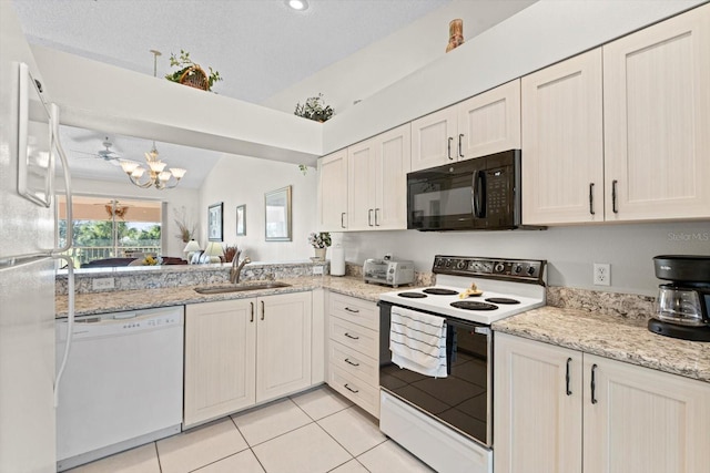 kitchen featuring light stone countertops, white appliances, sink, lofted ceiling, and light tile patterned flooring