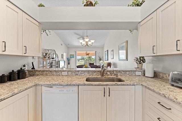 kitchen with dishwasher, sink, an inviting chandelier, kitchen peninsula, and lofted ceiling